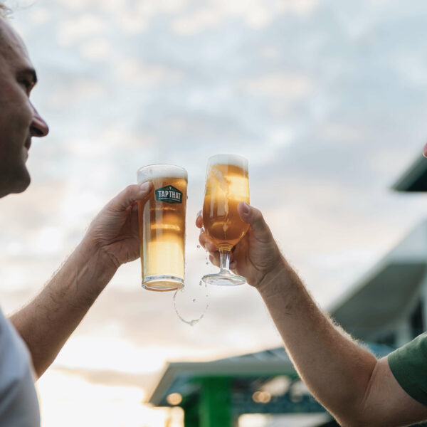 Outdoor entertaining setup with home beer system, lighting, snacks, and craft beer